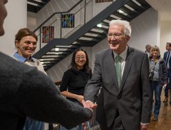 Ministerpräsident Winfried Kretschmann wird von einer Forschungsgruppe am Max-Planck-Institut für biologische Kybernetik begrüßt.
