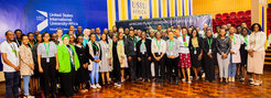 Over a hundred participants of the symposium posing for a picture in the hallway of the United States International University-Africa. They are standing in front of a banner that reads “African Plant Symposium".